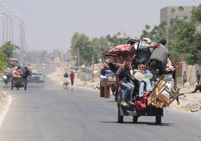 July 2, 2024, Khan Yunis, Gaza Strip, Palestinian Territory: Palestinians, who fled the eastern part of Khan Younis after they were ordered by the Israeli army to evacuate their neighborhoods, ride on a vehicle loaded with belongings, amid ongoing Israel war