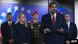 President Nicolás Maduro addresses the press, accompanied by his wife Cilia Flores, military chiefs and bodyguards, at the headquarters of the Supreme Court of Justice in Caracas, on August 2, 2024.