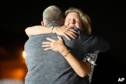 Elizabeth Whelan hugs her brother Paul Whelan at Andrews Air Force Base, Maryland, following their release as part of a 24-person prisoner exchange between Russia and the United States, August 1, 2024.