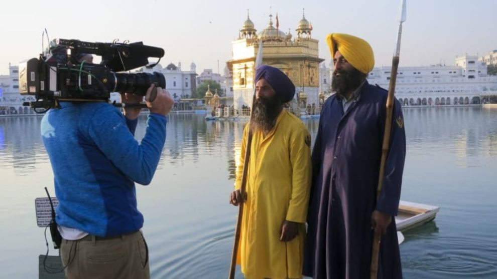 Two men outside the Golden Temple, a central place of prayer for Sikhs in Amritsar, India.