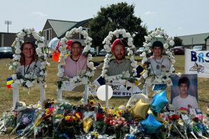 Posters with images of the victims of the attack, from left, Cristina Irimie, Mason Schermerhorn, Richard Aspinwall and Christian Angulo, are displayed at a memorial outside Apalachee High School in Winder, Georgia, on Sept. 10, 2024.