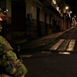 Ecuadorian policemen check the documents of a couple of motorcyclists on a street during a scheduled national rationing of electricity due to maintenance of the transmission system and distribution networks, in Quito on September 18, 2024.