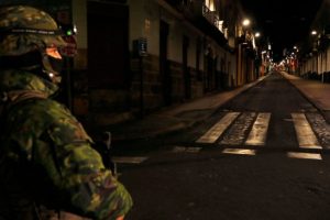 Ecuadorian policemen check the documents of a couple of motorcyclists on a street during a scheduled national rationing of electricity due to maintenance of the transmission system and distribution networks, in Quito on September 18, 2024.