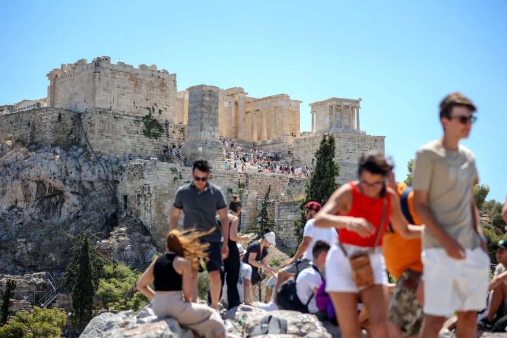 Tourists leave the Acropolis hill in Athens, July 17, 2024. The site was closed at 12 pm for five hours to protect visitors from the heat.