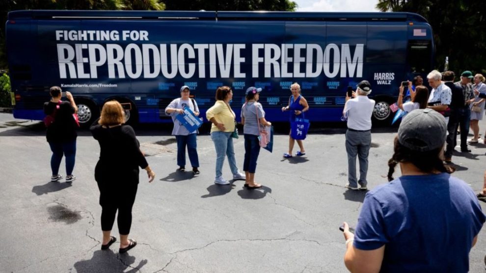 People take photos of the Reproductive Freedom Bus during the kickoff of the Harris-Walz campaign's reproductive rights bus tour in Boynton Beach, Florida, on Sept. 3.