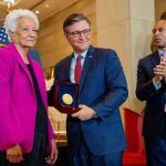 House Minority Leader Hakeem Jeffries (right) applauds as House Speaker Mike Johnson poses with Wanda Jackson (left) while accepting a Congressional Gold Medal on behalf of Mary Jackson during a ceremony on Capitol Hill on Wednesday.