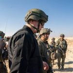 Israeli Defense Minister Yoav Gallant with military personnel on the ground