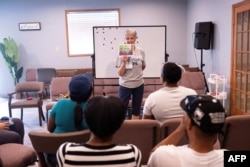 Volunteer teacher Hope Kaufman teaches English language classes to Haitian students at the Haitian Community Outreach and Support Center in Springfield, Ohio, on Sept. 13, 2024.