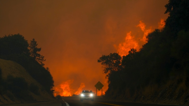 Lightning could worsen a wildfire east of Los Angeles that already threatens 35,000 homes and buildings