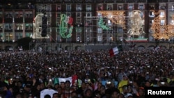 People attend the day of "Cry of Independence"marking Mexico's independence from Spain, in downtown Mexico City, Mexico, September 15, 2024. REUTERS/Henry Romero