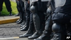 Nicaraguan riot police stand in formation as a group of doctors, nurses and medical students protest against the government of President Daniel Ortega, in Managua, Nicaragua, Saturday, August 3, 2019.