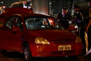 Police officers inspect the car of the director in charge of the Centro de Privación de Libertad Masculina N°1 del Guayas, María Daniela Icaza, after being attacked in Guayaquil, Ecuador, on 12 September 2024. The director of a prison in Guayaquil, Ecuador's and the scene of some of the worst inmate killings, was murdered on Thursday, becoming the second prison official to be killed in ten days, the agency in charge of prisons (SNAI) said. (Photo by MARCOS PIN / AFP) (Photo by MARCOS PIN/AFP via Getty Images)