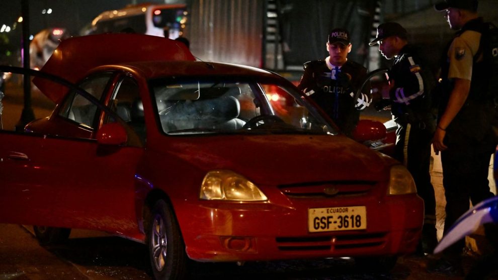 Police officers inspect the car of the director in charge of the Centro de Privación de Libertad Masculina N°1 del Guayas, María Daniela Icaza, after being attacked in Guayaquil, Ecuador, on 12 September 2024. The director of a prison in Guayaquil, Ecuador's and the scene of some of the worst inmate killings, was murdered on Thursday, becoming the second prison official to be killed in ten days, the agency in charge of prisons (SNAI) said. (Photo by MARCOS PIN / AFP) (Photo by MARCOS PIN/AFP via Getty Images)