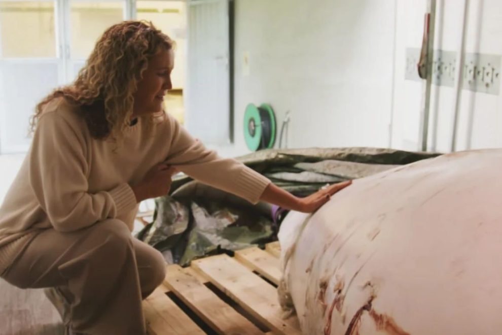 This photo provided by OneWhale.org on Sept. 4 shows manager Regina Haug next to the carcass of the beluga whale Hvaldimir, which was found dead on Aug. 31. Credit: OneWhale.org/AP