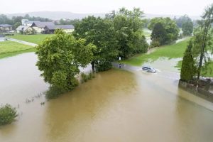 A car drives through a flooded street in Braunau am Inn, Austria.