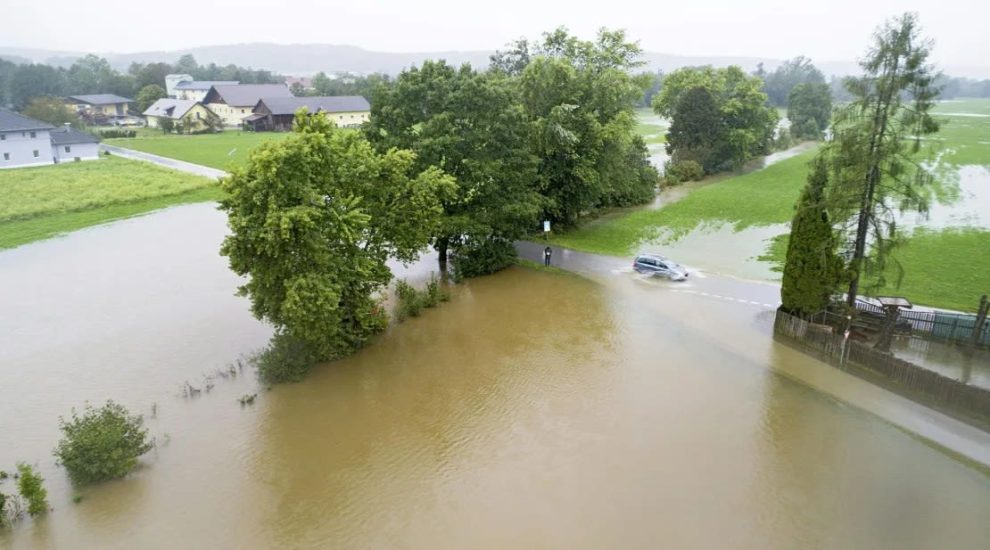 A car drives through a flooded street in Braunau am Inn, Austria.