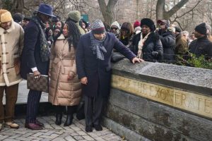 Kevin Richardson, far left, Yusef Salaam, second from left, and Raymond Santana Jr., far right in foreground, three of the five men exonerated after being wrongfully convicted as teenagers of the 1989 rape of a jogger in Central Park, stand next to the new