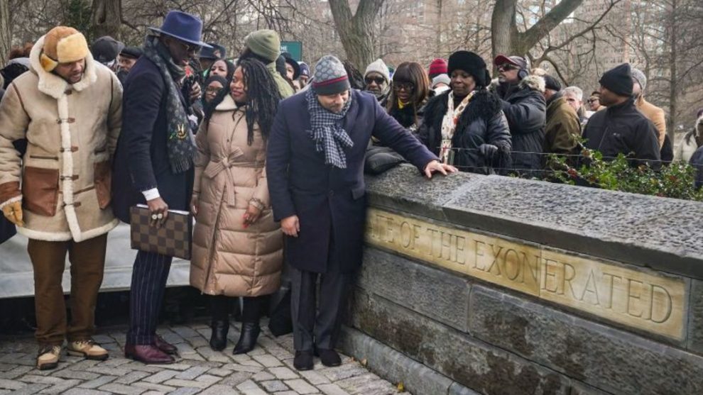 Kevin Richardson, far left, Yusef Salaam, second from left, and Raymond Santana Jr., far right in foreground, three of the five men exonerated after being wrongfully convicted as teenagers of the 1989 rape of a jogger in Central Park, stand next to the new