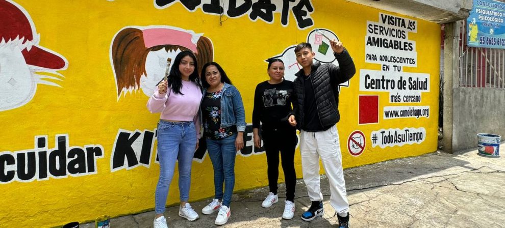 Ana Fernanda and Ricardo celebrate the completion of their mural in San Gregorio, Xochimilco, with their mothers.