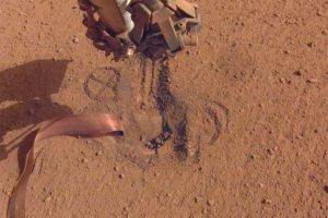 File - NASA's InSight retracted its robotic arm on October 3, 2020, revealing where the "mole" spike-shaped is trying to dig into Mars.