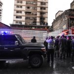 Security forces search a nearby building after a drone loaded with explosives detonated during a speech by Venezuelan President Nicolás Maduro in Caracas on August 4, 2018.