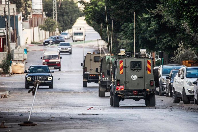 Israeli Army trucks in the West Bank city of Nablus