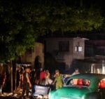 Cuban police and military stand next to debris used to block a street during a protest against a blackout, after opening the street to traffic, in Havana, Cuba, on October 19, 2024.