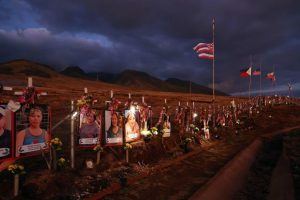 Images and crosses are displayed at a public hillside memorial honoring victims of the Lahaina wildfires, August 1, 2024, in Lahaina, Hawaii. August 8 marks one year since the Maui wildfires that killed 102 people and devastated the historic community of Lahaina in West Maui. Hawaii Gov. Josh Green announced that parties involved in wildfire lawsuits against the government and utility companies are close to settling claims that will total about $4 billion.