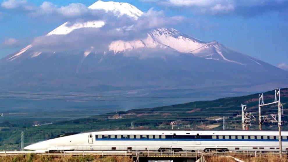 A Shinkansen train speeds past Mt.