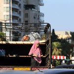 A girl flees southern Beirut due to Israeli bombings