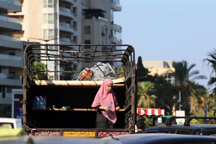 A girl flees southern Beirut due to Israeli bombings