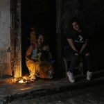 Residents pass the time during a blackout following the failure of a major power plant in Havana, Cuba, on Saturday, October 19, 2024.