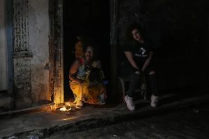 Residents pass the time during a blackout following the failure of a major power plant in Havana, Cuba, on Saturday, October 19, 2024.