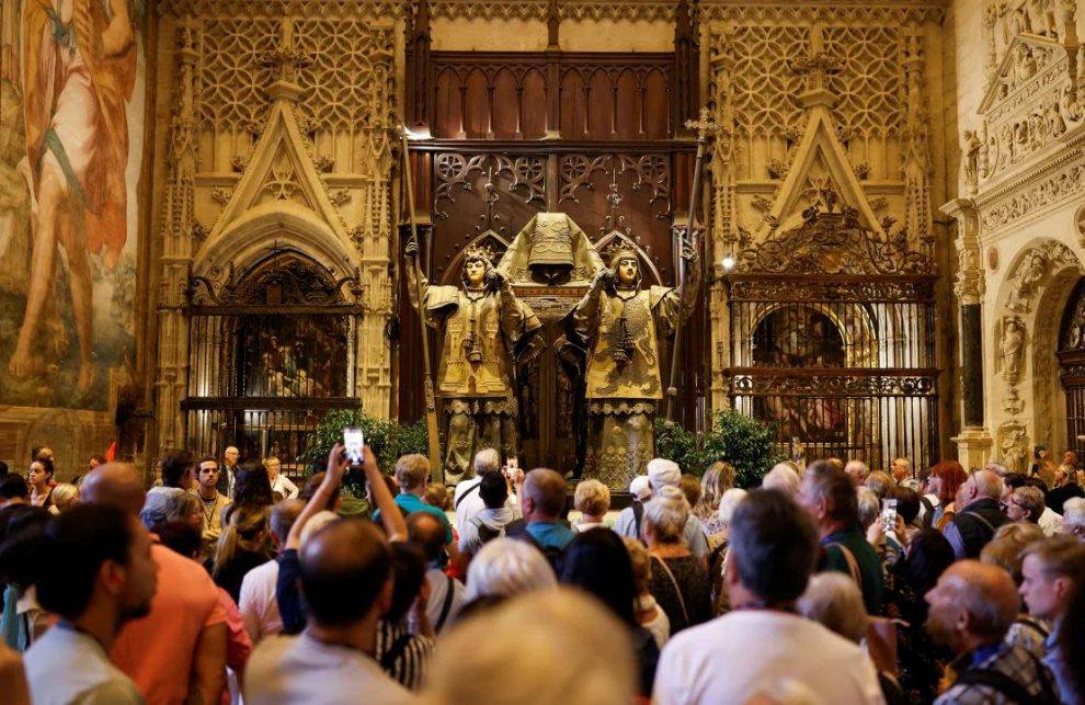 A group of people visit the mausoleum of Christopher Columbus at the cathedral in Seville, Spain, on October 11, 2024.