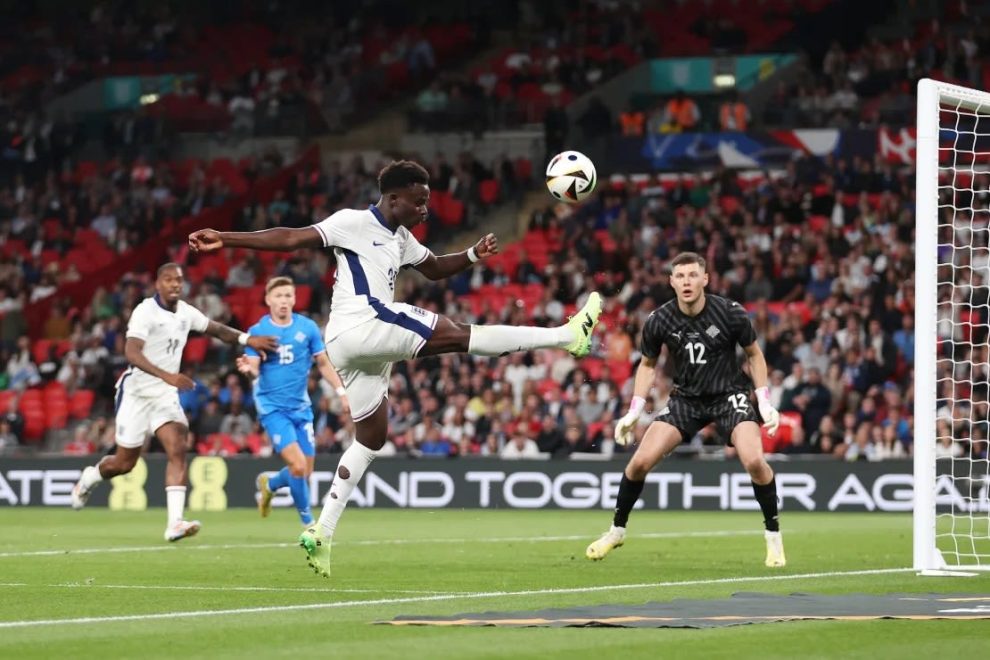 Bukayo Saka of England tries to keep the ball in play during the International Friendly match between England and Iceland at Wembley Stadium on June 07, 2024 in London, England.