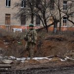 File - A Ukrainian soldier in a crater in front of an apartment building in Chasiv Yar, Donetsk province, eastern Ukraine (file)