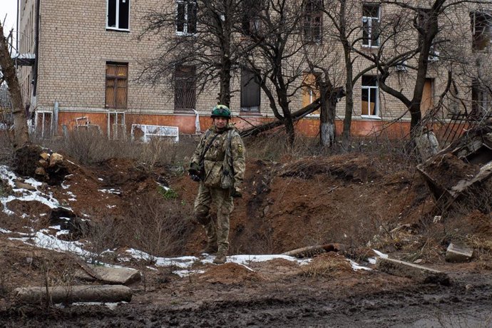 File - A Ukrainian soldier in a crater in front of an apartment building in Chasiv Yar, Donetsk province, eastern Ukraine (file)