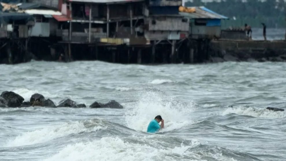 A resident swims despite strong waves caused by Tropical Storm Trami in Manila, Philippines, on October 23, 2024.