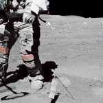 Astronaut John W. Young collects samples of lunar regolith.