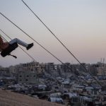 A girl swings in the Khan Younis displaced persons camp in the southern Gaza Strip