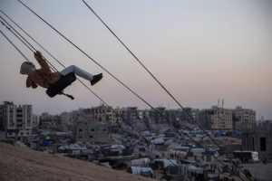 A girl swings in the Khan Younis displaced persons camp in the southern Gaza Strip