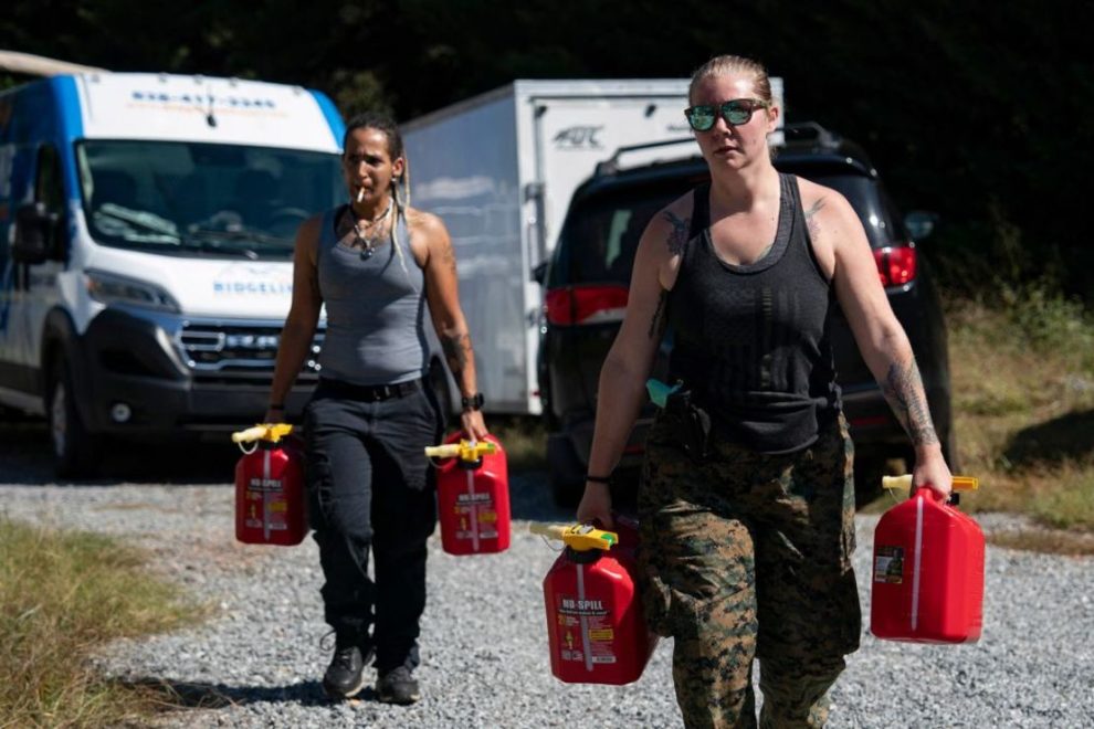 Community volunteers haul gasoline Thursday at a relief zone and community coordination center in Bills Creek, North Carolina. Credit: Allison Joyce/AFP/Getty Images