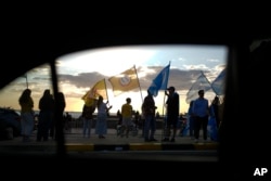 Members of a political party demonstrate a day before the general elections, in Montevideo, Uruguay, Saturday, October 26, 2024. (AP Photo/Natacha Pisarenko)