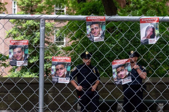 File - June 2, 2024, New York, United States: NYPD officers stand guard in front of a temporary security fence installed the night before, between Central Park and Fifth Ave. The 59th Annual Israel Day parade marches up 5th Avenue along Central Park. T