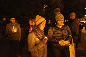 Friends hold candles as they remember Mackenzie Michalski, a 31-year-old American tourist who died while on vacation, during a candlelight vigil in Budapest, Hungary, on Nov. 9, 2024.