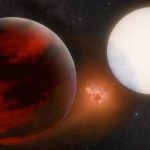 This artist's conception depicts a possible volcanic moon between exoplanet WASP-49 b, left, and its parent star.