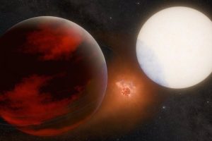 This artist's conception depicts a possible volcanic moon between exoplanet WASP-49 b, left, and its parent star.