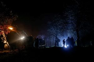 People stand near the damaged canal in northern Kosovo that supplies water to two coal-fired power plants that generate almost all of the country's electricity, in Varage, Kosovo, on November 30, 2024.