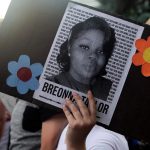 A protester holds a sign with the image of Breonna Taylor during a protest in Denver, Colorado, on June 3, 2020.