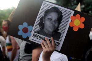 A protester holds a sign with the image of Breonna Taylor during a protest in Denver, Colorado, on June 3, 2020.